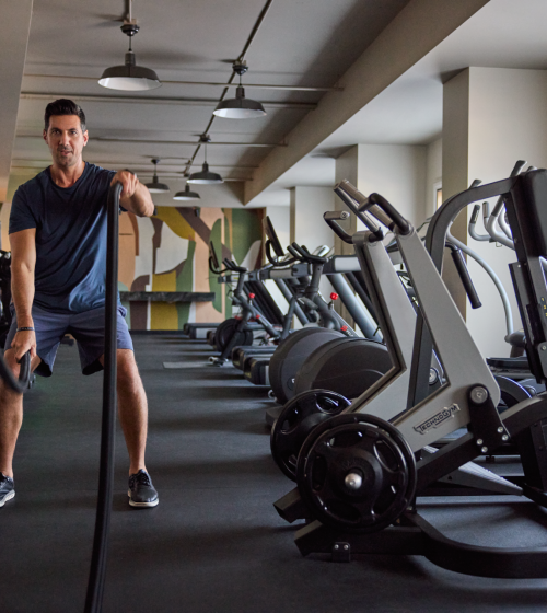 A man working out in the gym at the Camby