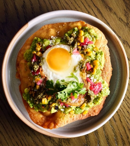 Fried bread with avocado and a sunny side up egg at Yellowbell