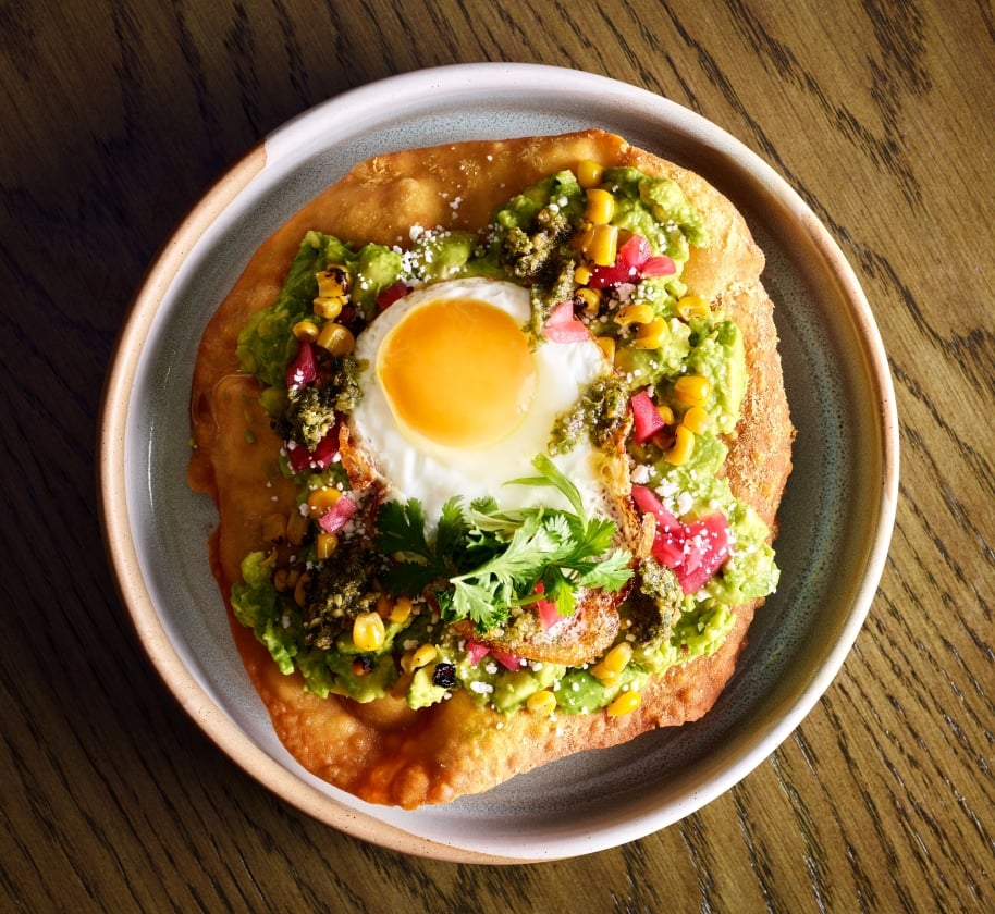 Fried bread with avocado and a sunny side up egg at Yellowbell