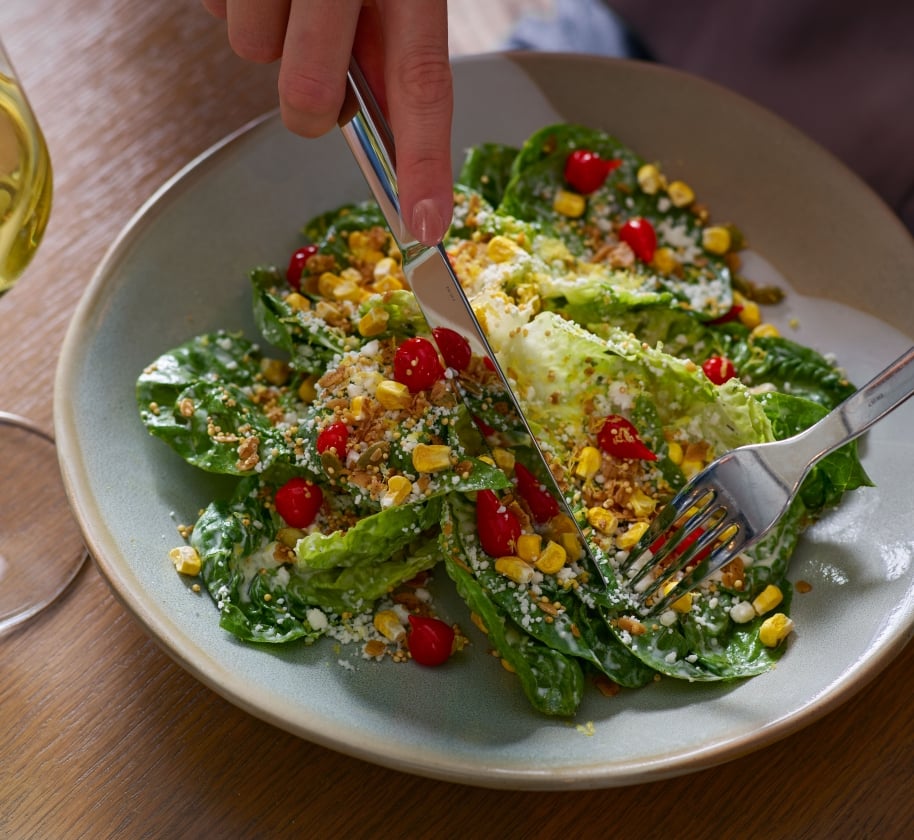 A salad with corn and romaine lettuce at Yellowbell