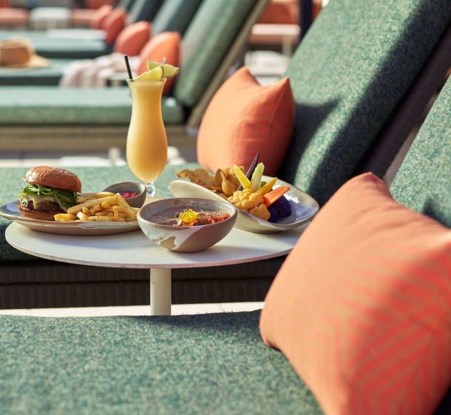 Pool side food on a lounge chair at the Camby