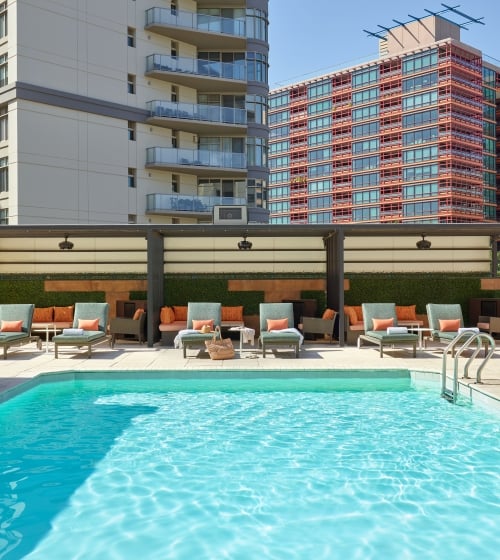 View of the pool amongst tall buildings at the Camby