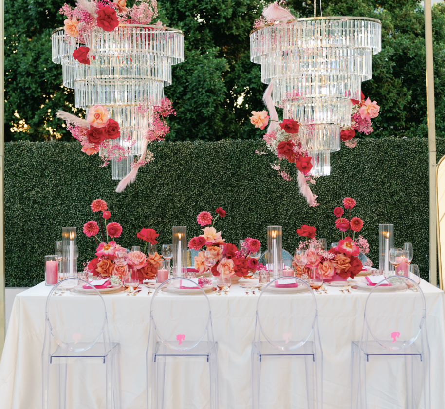 2 large chandeliers above a table at an outdoor wedding venue at the Camby