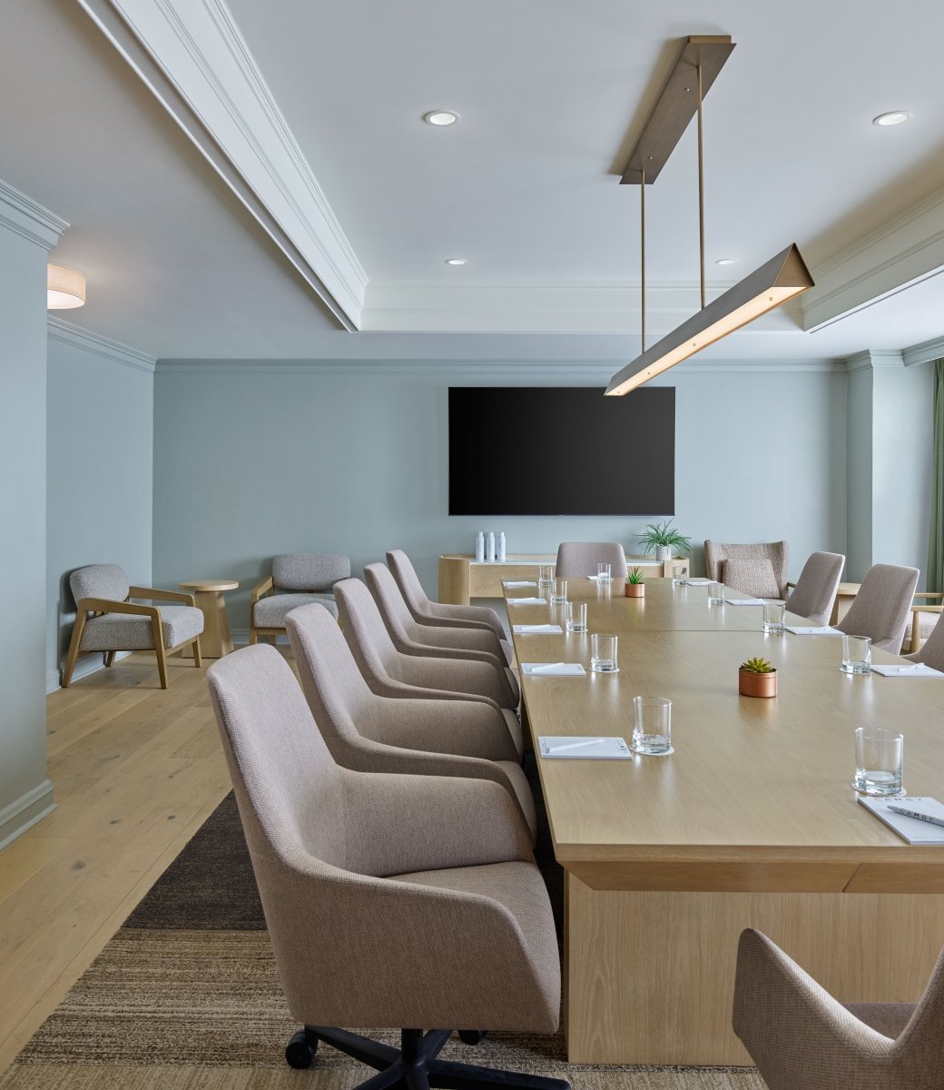 An indoor meeting space at the Camby with a long table and chairs