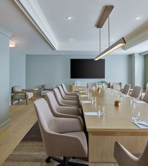 An indoor meeting space at the Camby with a long table and chairs