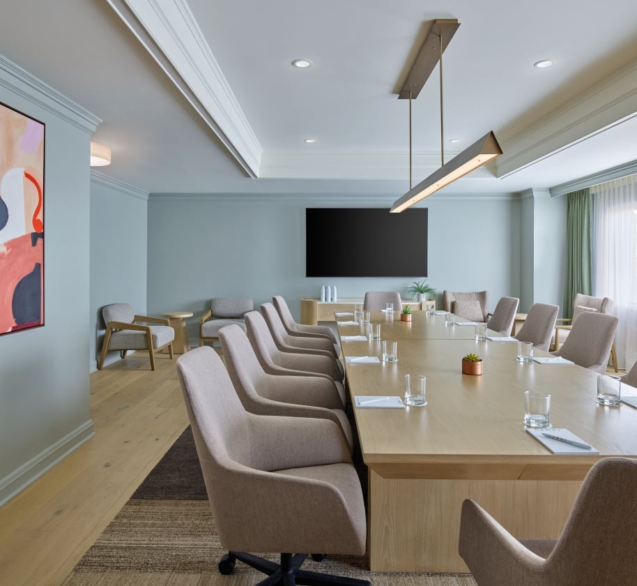 An indoor meeting space at the Camby with a long table and chairs