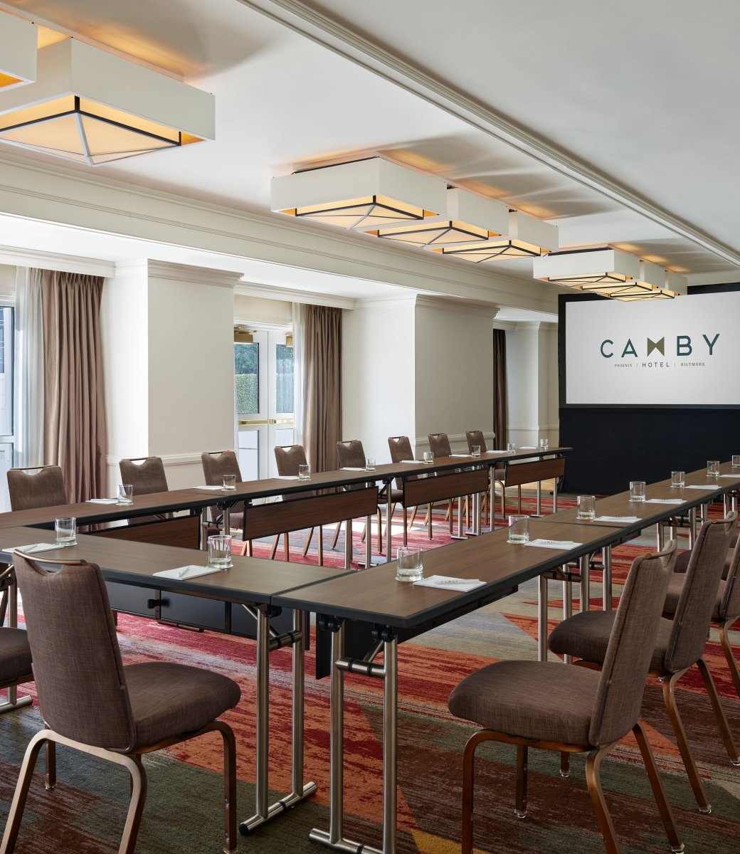 A large indoor meeting room at the Camby with tables connected in a 