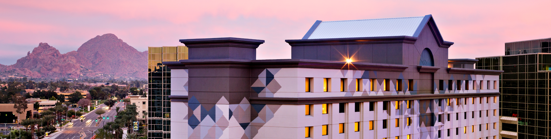 Exterior of the Camby with a view of the mountains behind it