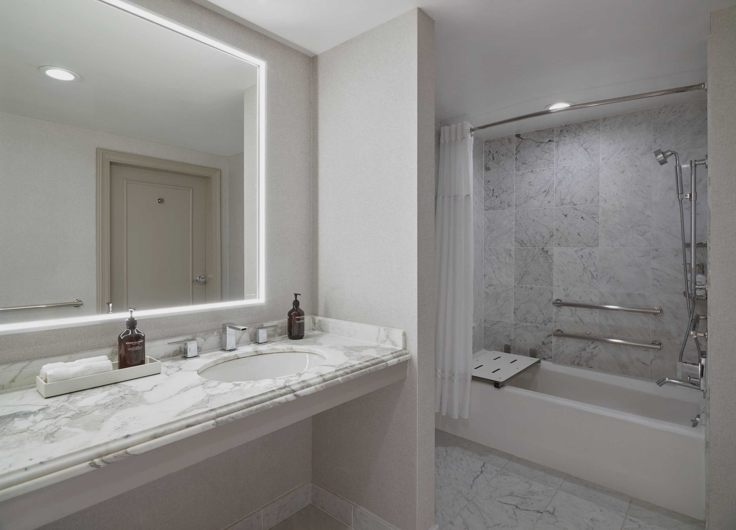 The washroom sink and tub inside the ADA room at the Camby