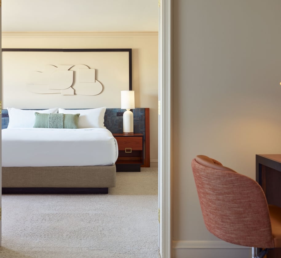 Bedroom and desk area of the Uptown Suite at the Camby