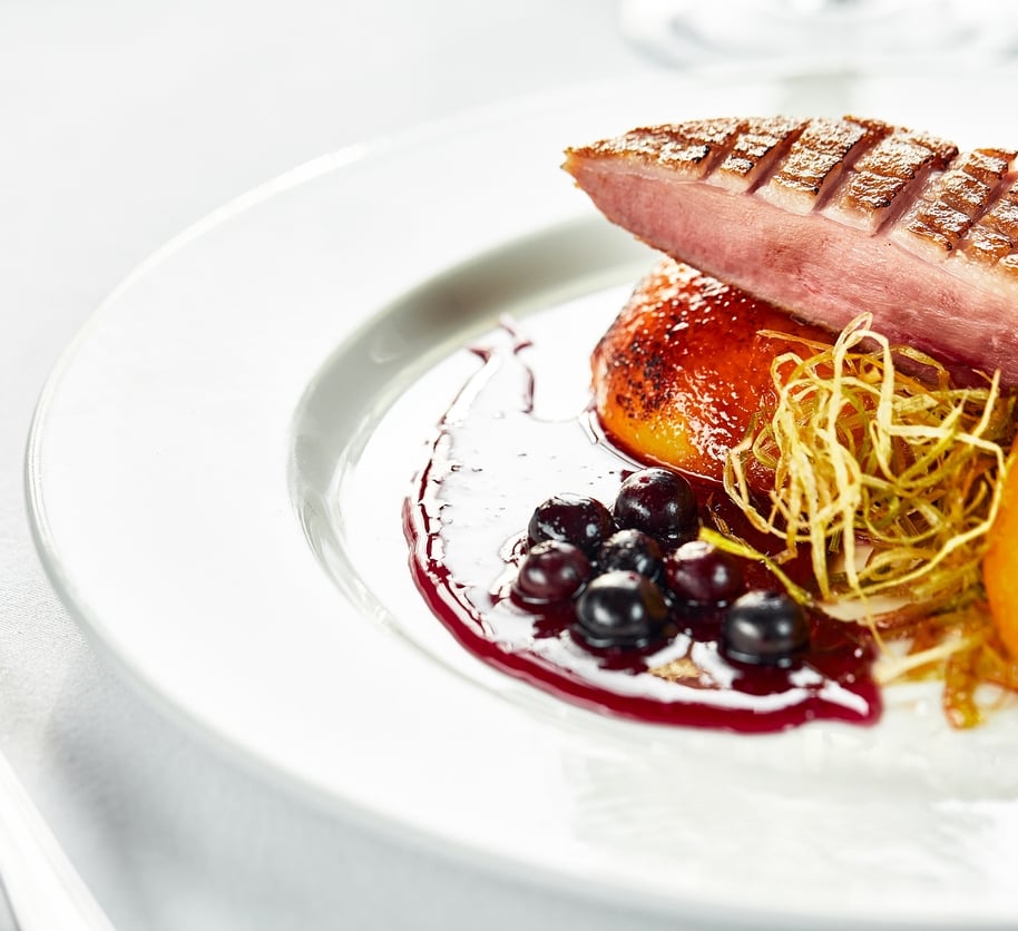 Grilled duck breast with peaches in berry sauce at the Camby