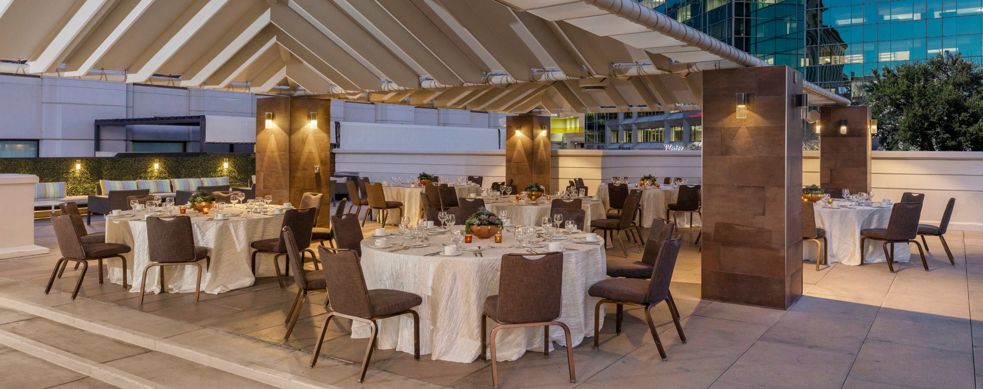 Rooftop venue space at the Camby with 6 large round tables set for service