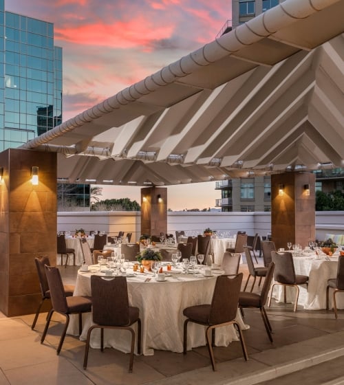 The pool deck venue setup for a gathering at sunset at the Camby