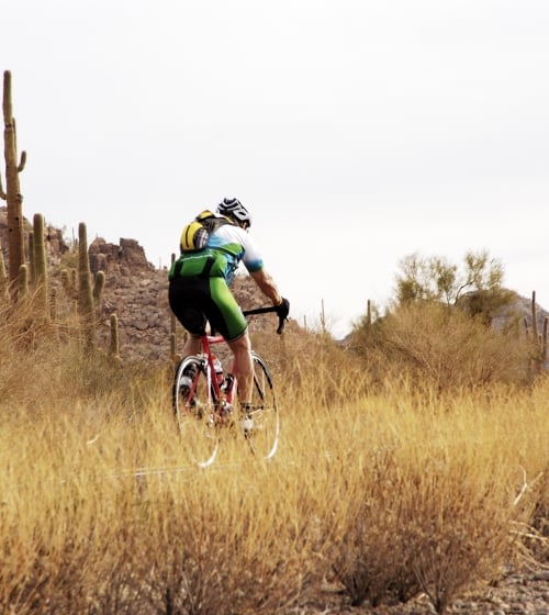 A man biking through the outback of Arizona