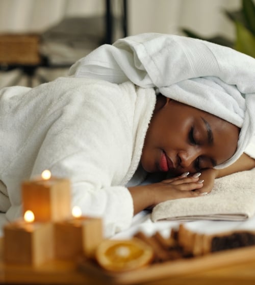 A woman laying on her stomach in a robe at the Phoenician Sap