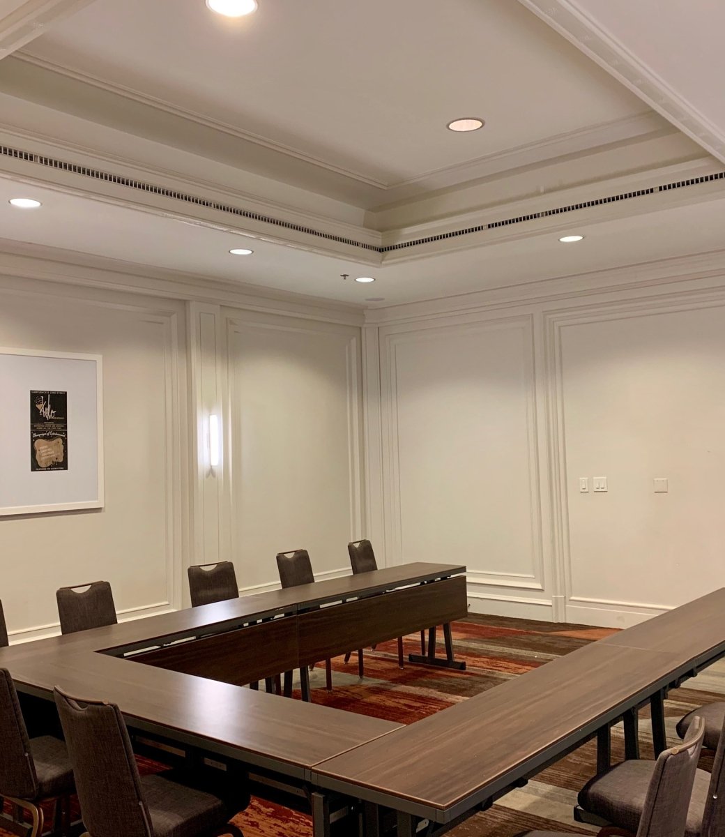 A u-shaped table setup in a venue at The Camby