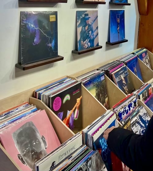 A woman looking through records at Zia Records in Arizona