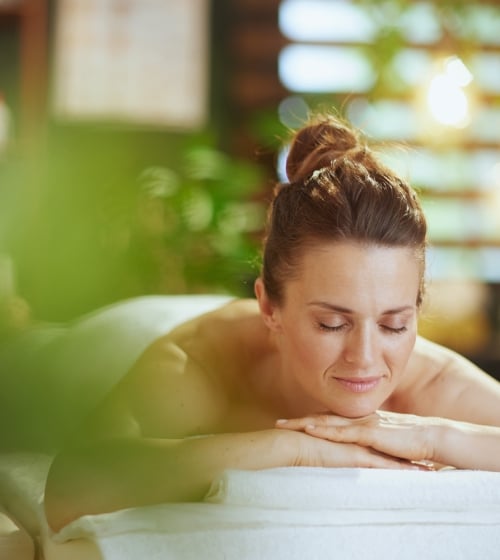 A woman relaxing on a spa bed at the Four Seasons