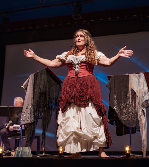 A woman on stage at the Arizona Opera